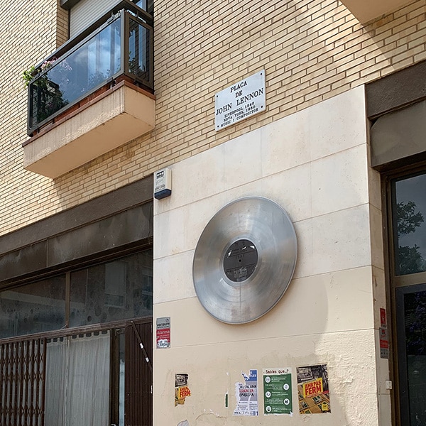 Album cover signifying that this location is Plaça de John Lennon in the Gràcia neighborhood of Barcelona.