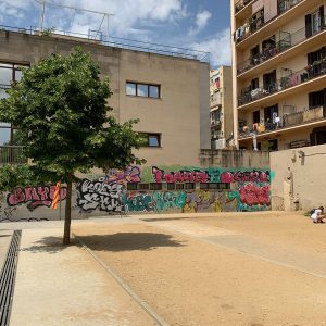 Graffiti wall and apartments in Barcelona's Plaça del Poble Romaní.