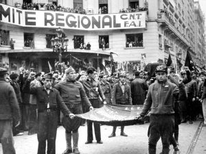 1936 - Republican miitia members, in front of CNT FAI headquarters, carry flag and coffin of Durruti.